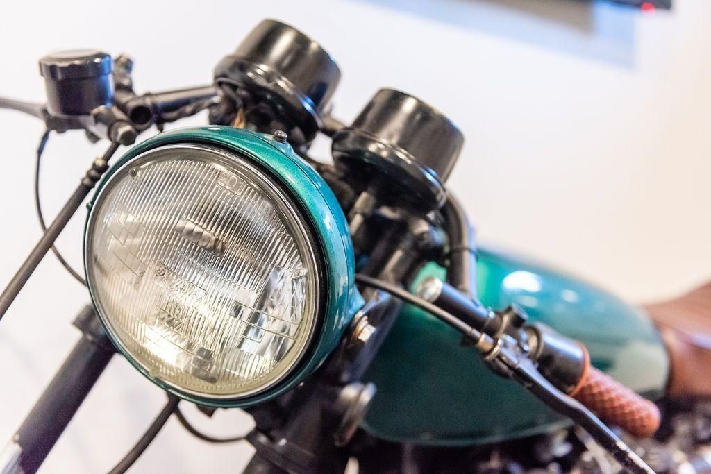 A close up of a motorcycle 's headlight and dashboard.