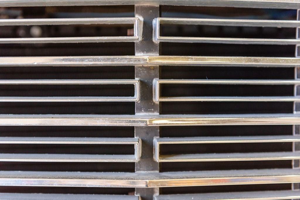 A close up of a metal grill on a car
