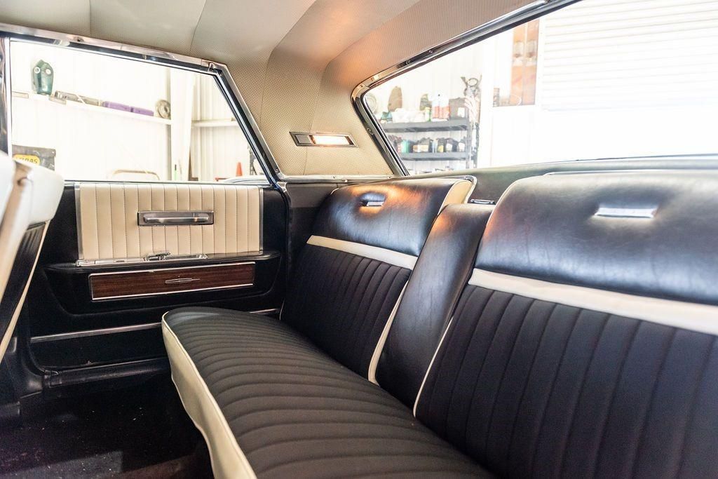 The back seat of a car with black and white seats