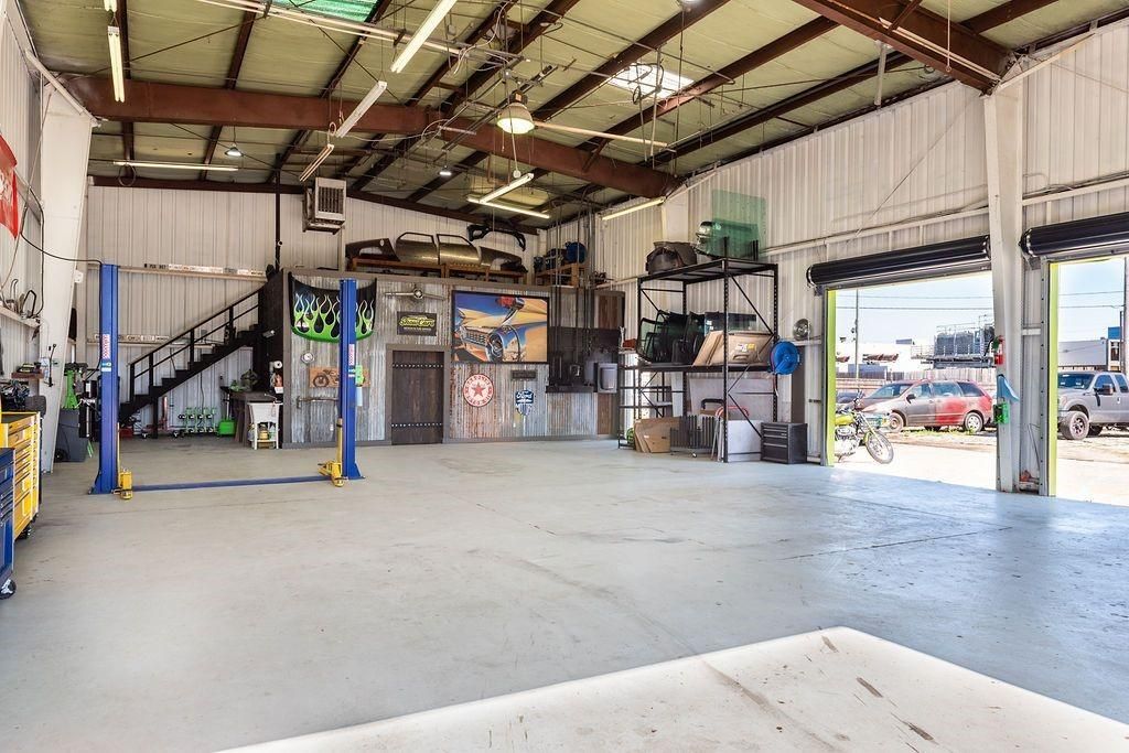 A large empty garage with two lifts in it.