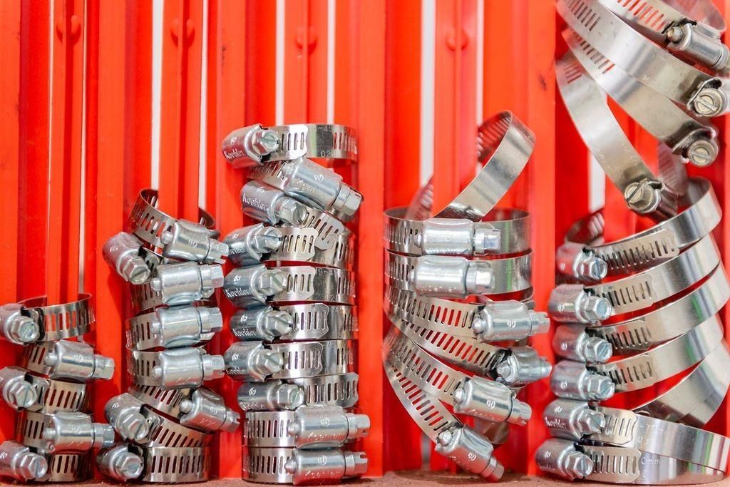 A bunch of hose clamps are stacked on top of each other on a table.