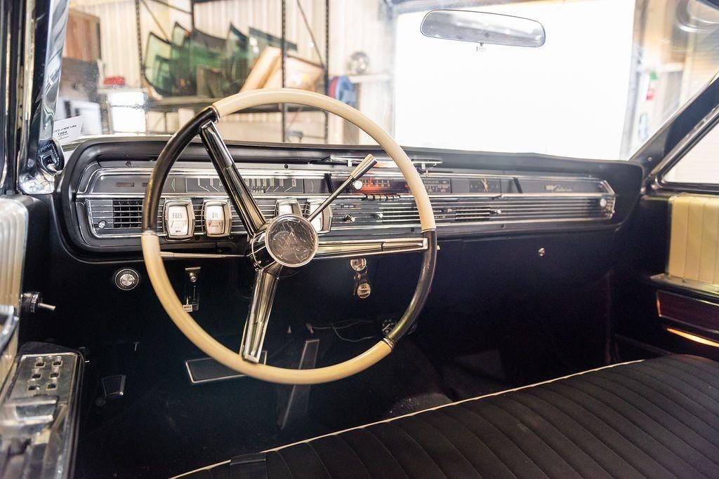 The interior of an old car with a steering wheel