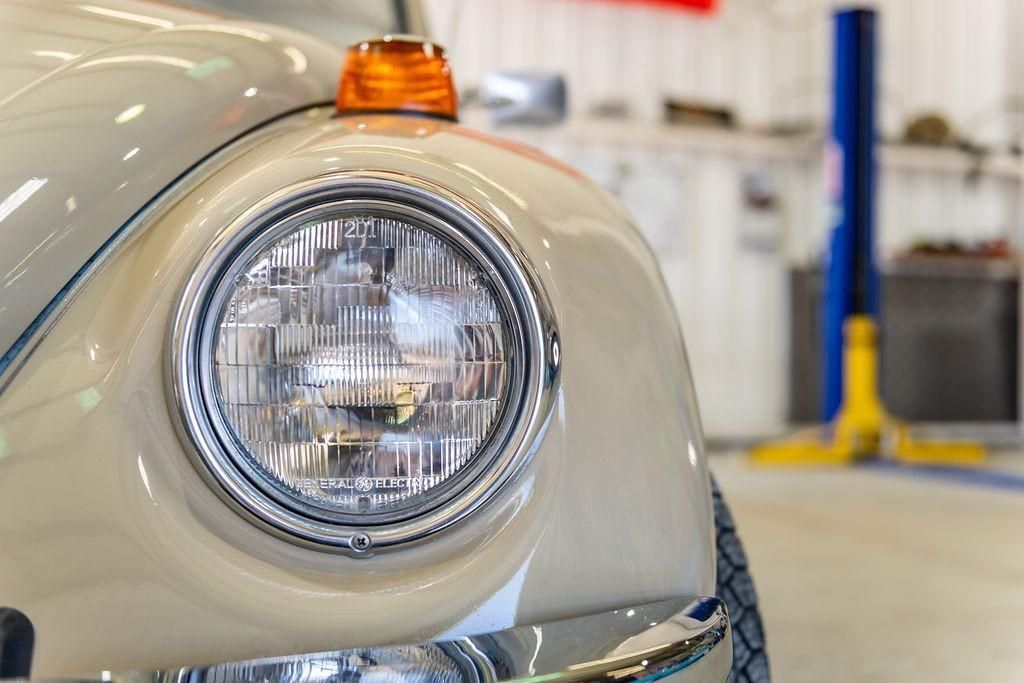 A close up of a car headlight in a garage.