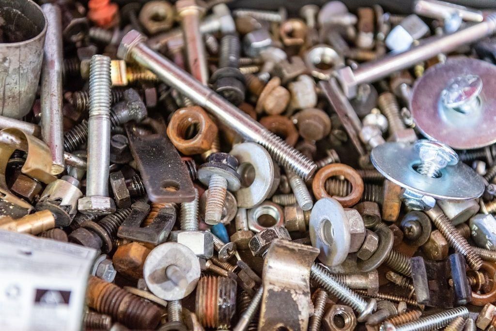 A pile of nuts and bolts on a table.