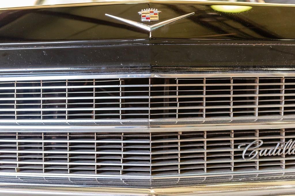 A close up of the front of a black cadillac