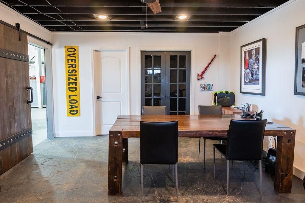 A room with a table and chairs and a sign that says oversized load