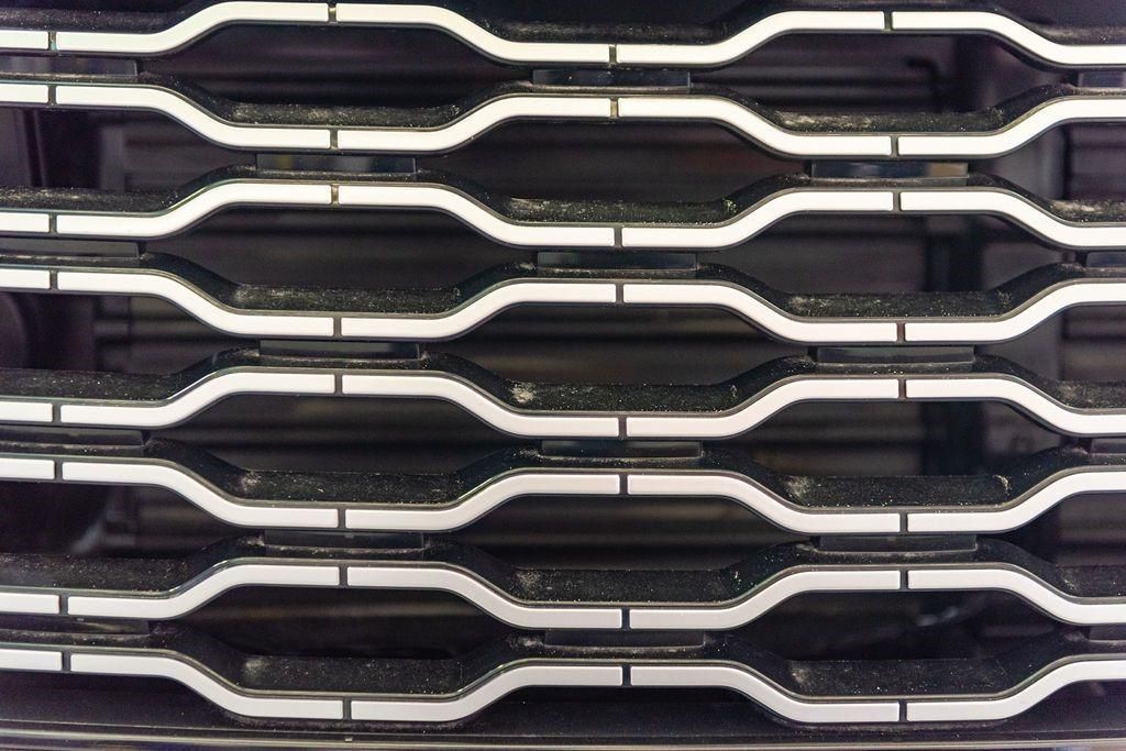 A close up of a black and white grille on a car