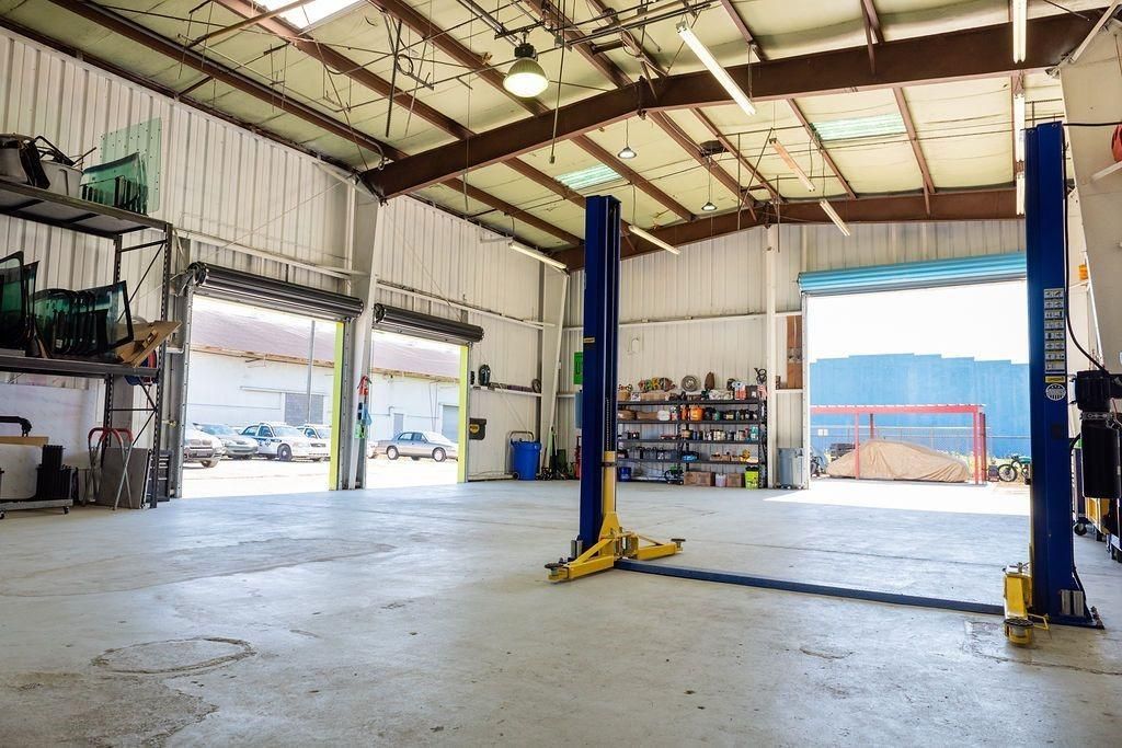 A large empty garage with two lifts in it.