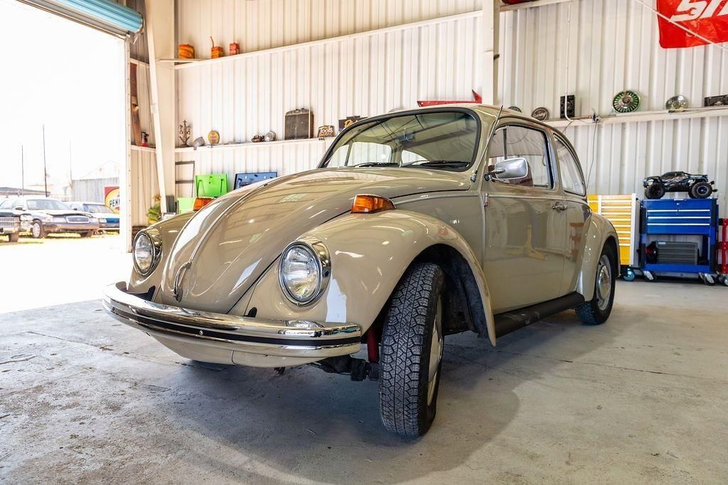 A volkswagen beetle is parked in a garage.