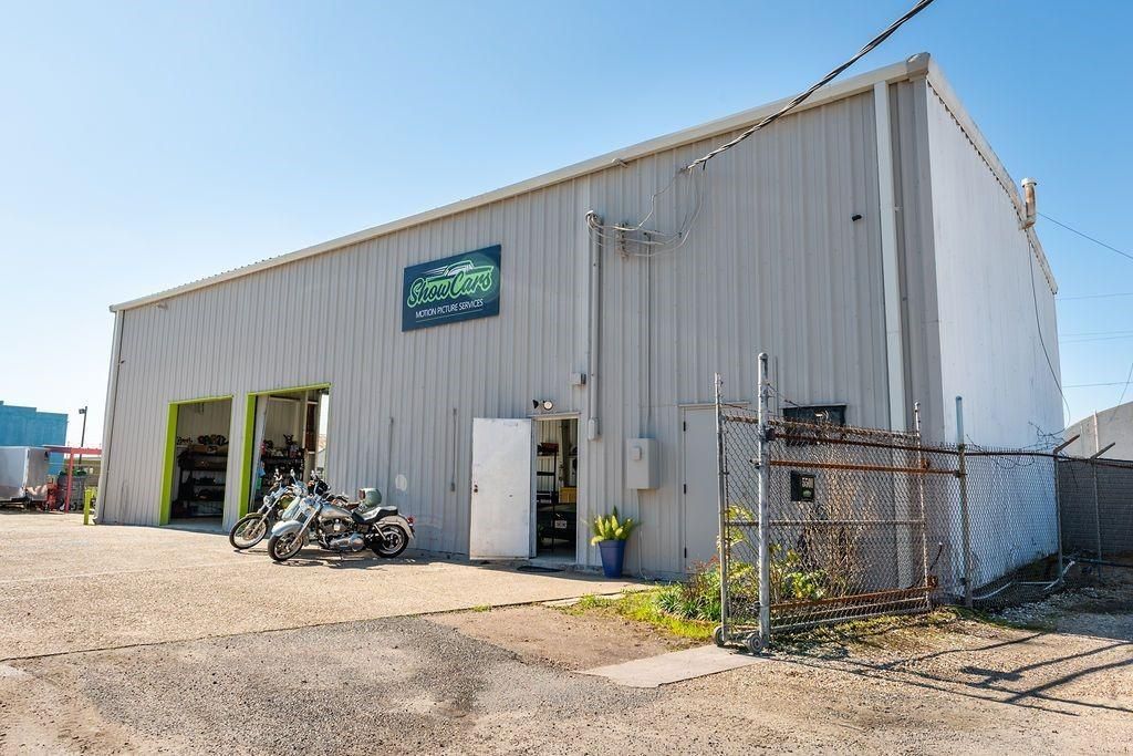 A large white building with motorcycles parked in front of it.