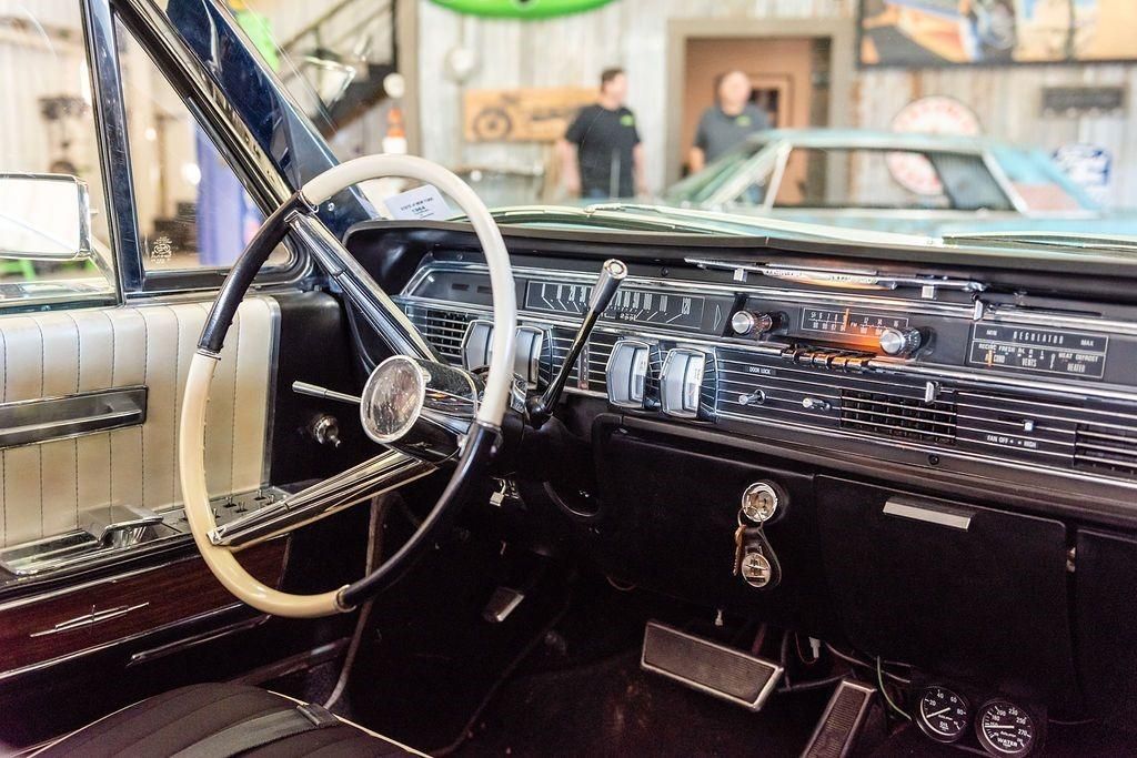 The inside of a car with a steering wheel and dashboard.