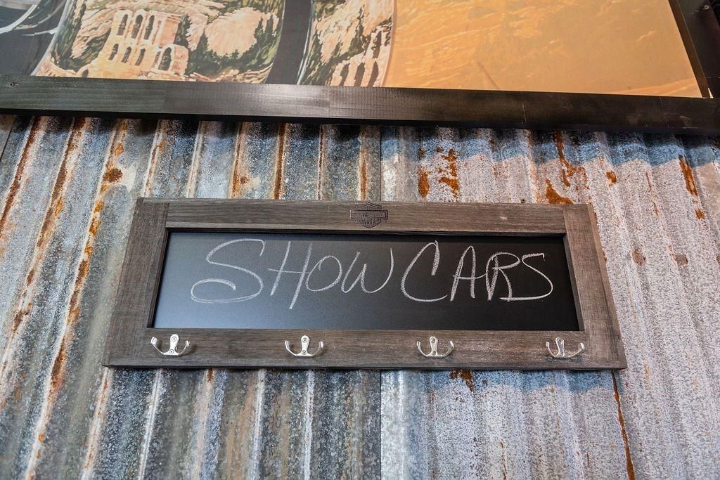 A chalkboard with the words show cars written on it