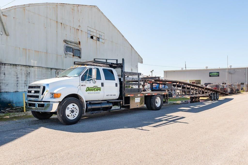 A white truck is parked in front of a building.