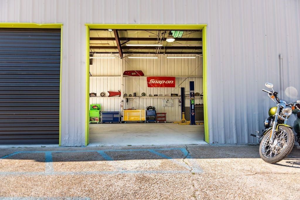 A motorcycle is parked in front of a garage door.