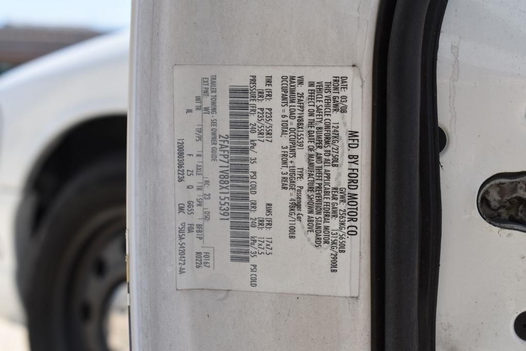 A white car has a sticker on the side that says vin