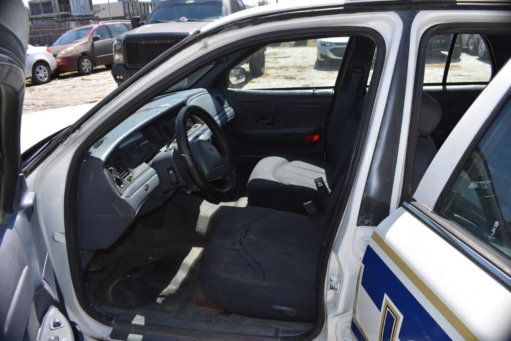 The inside of a police car with the door open