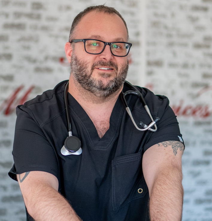 Four medical professionals smiling, with stethoscopes.
