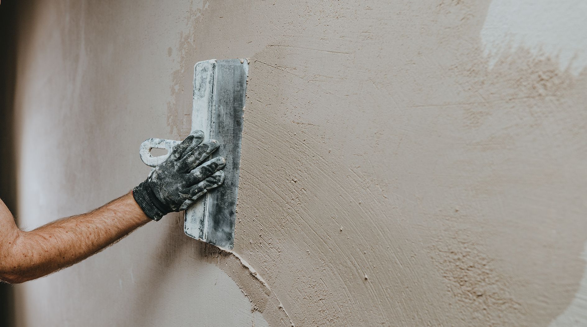 male builder work overalls plastering wall