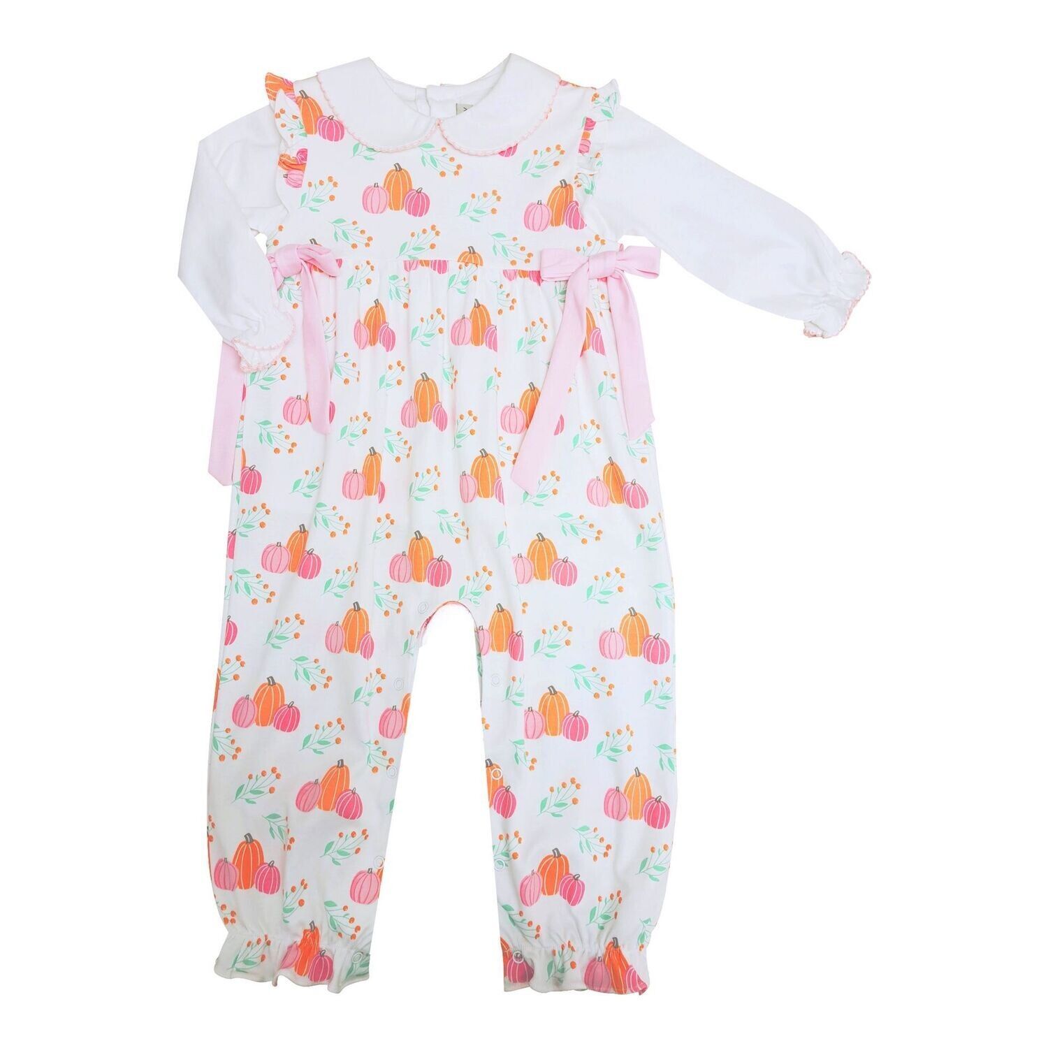 Baby girl's jumpsuit with a white long-sleeved shirt underneath. The jumpsuit is patterned with pumpkins in pink and orange.