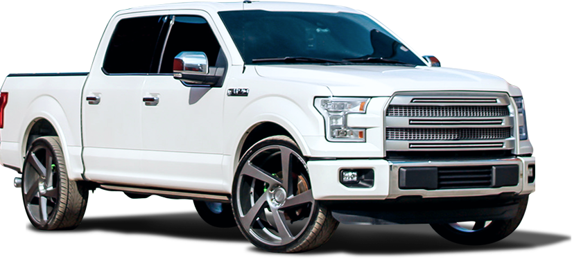 White Ford pickup truck with large grey rims.