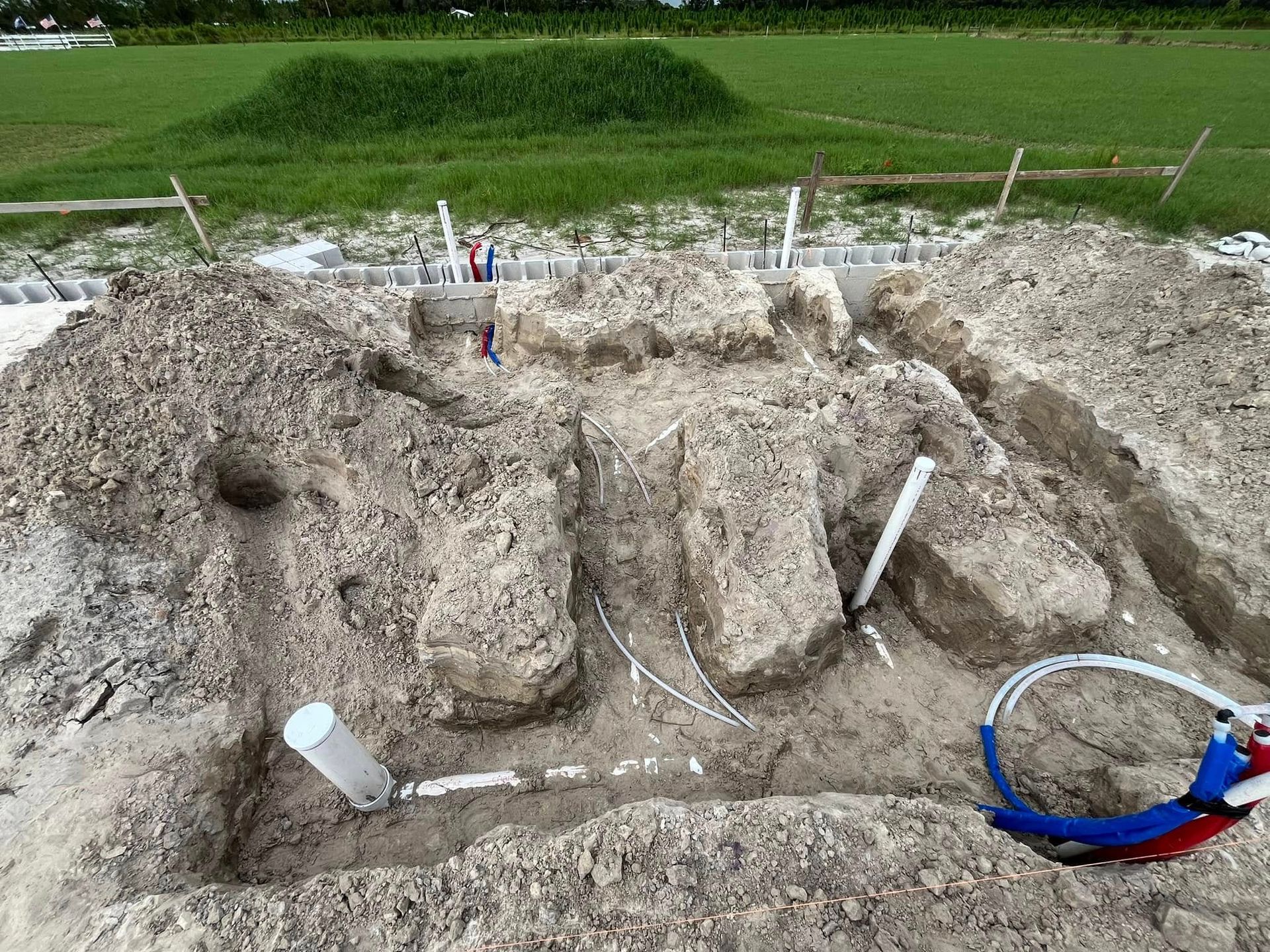 A pile of dirt with a blue ring in the middle of it.