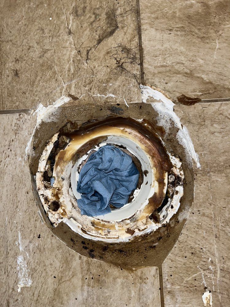 A close up of a hole in a wall with a blue cloth in it.