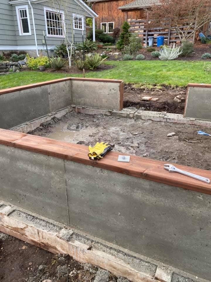 a concrete wall is being built in front of a house