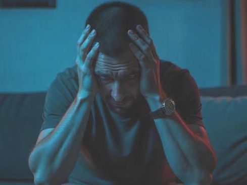 Columbus OH Man dealing with PTSD holding his head in his hands