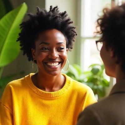 A man is laying on a couch talking to a woman.