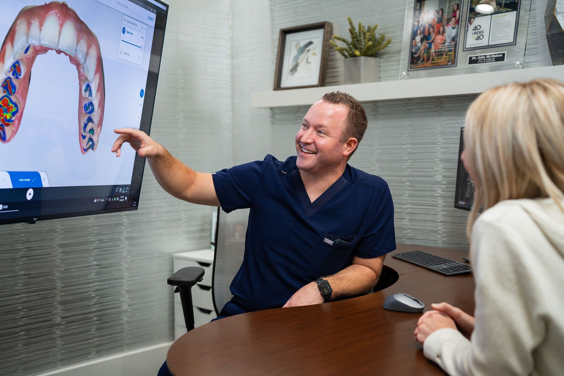 Woman smiling in a hand mirror, dental X-ray in background. Dentist's office setting.