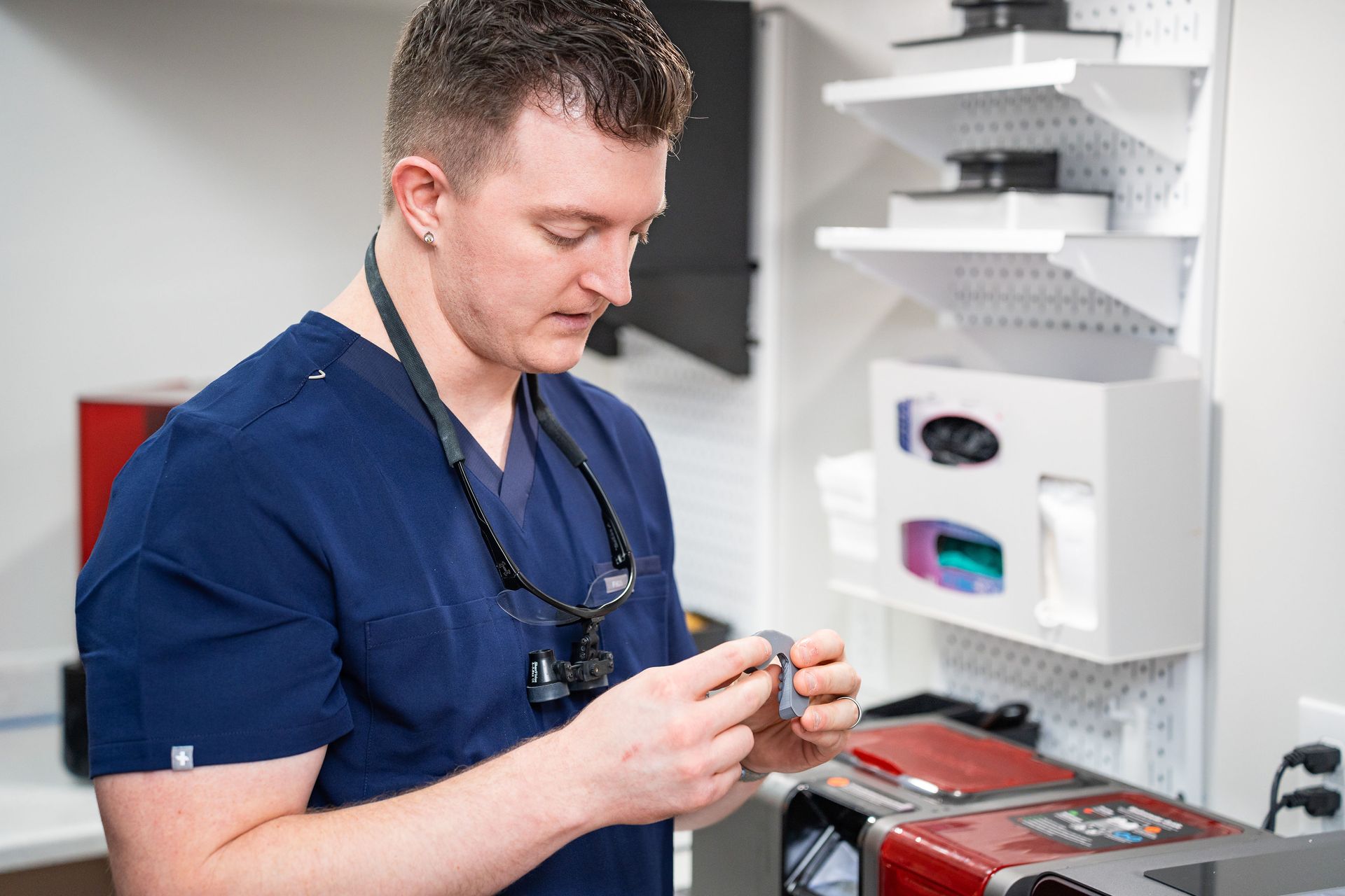 Dentist using scanner on patient, showing 3D teeth image on monitor.