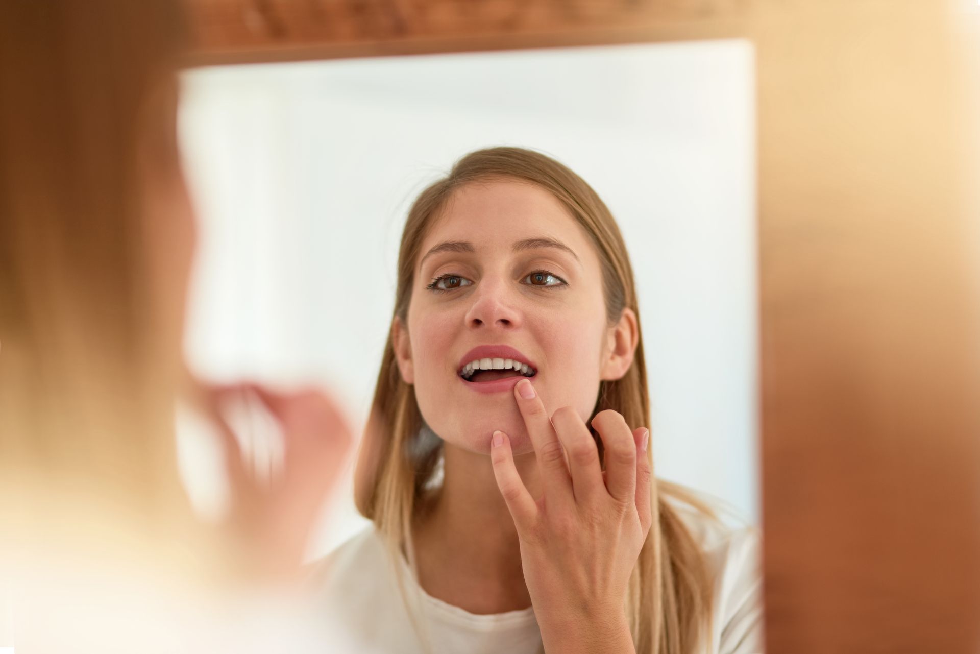 Dentist talking to a patient in a dental office; both are seated.