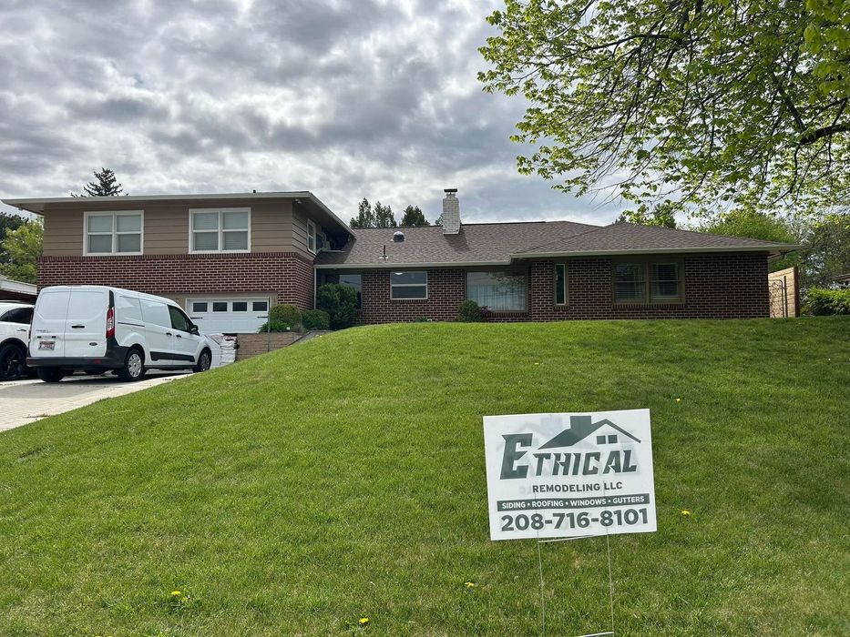 A house with a sign in front of it that says ethical roofing.