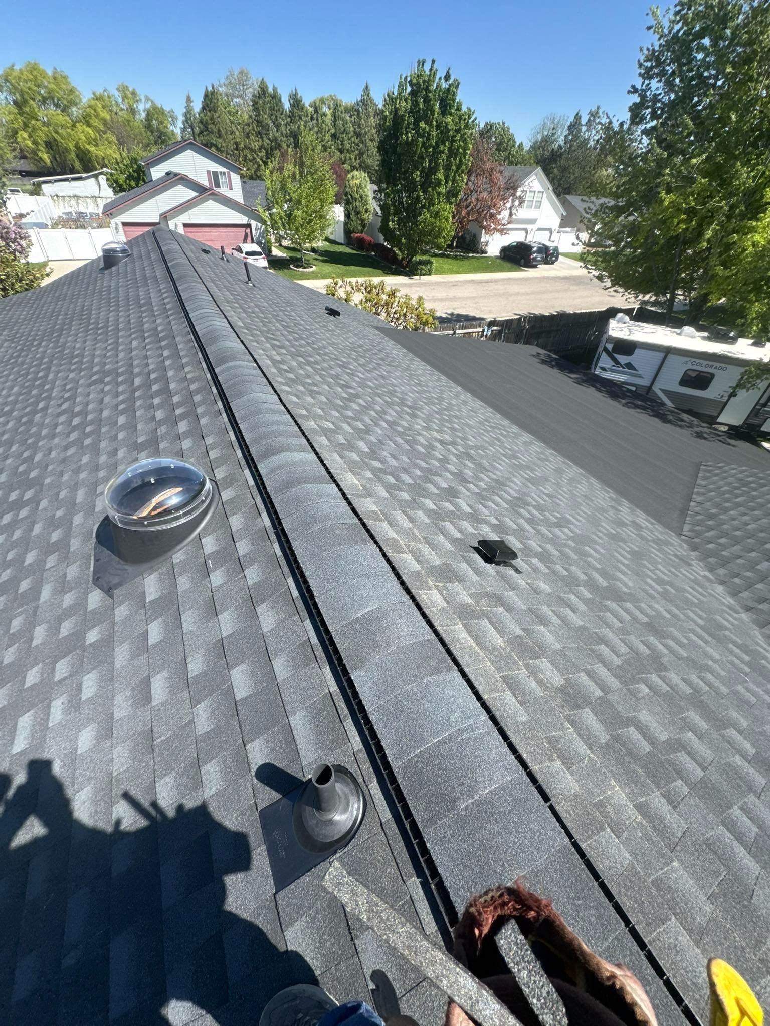 A person is working on the roof of a house.