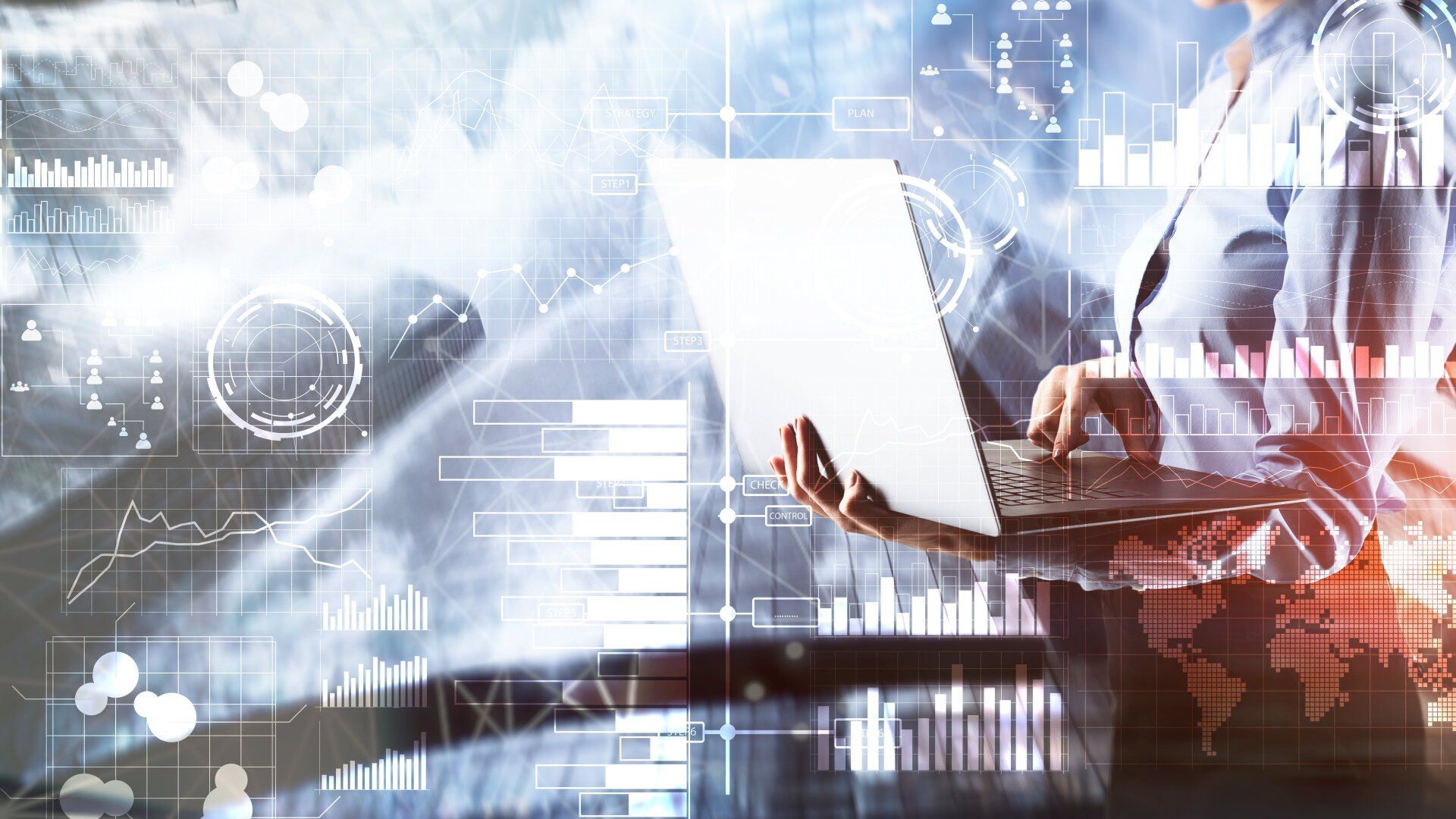 Person holds a laptop with digital graphs and data overlays in the background, symbolizing technology and data analysis.