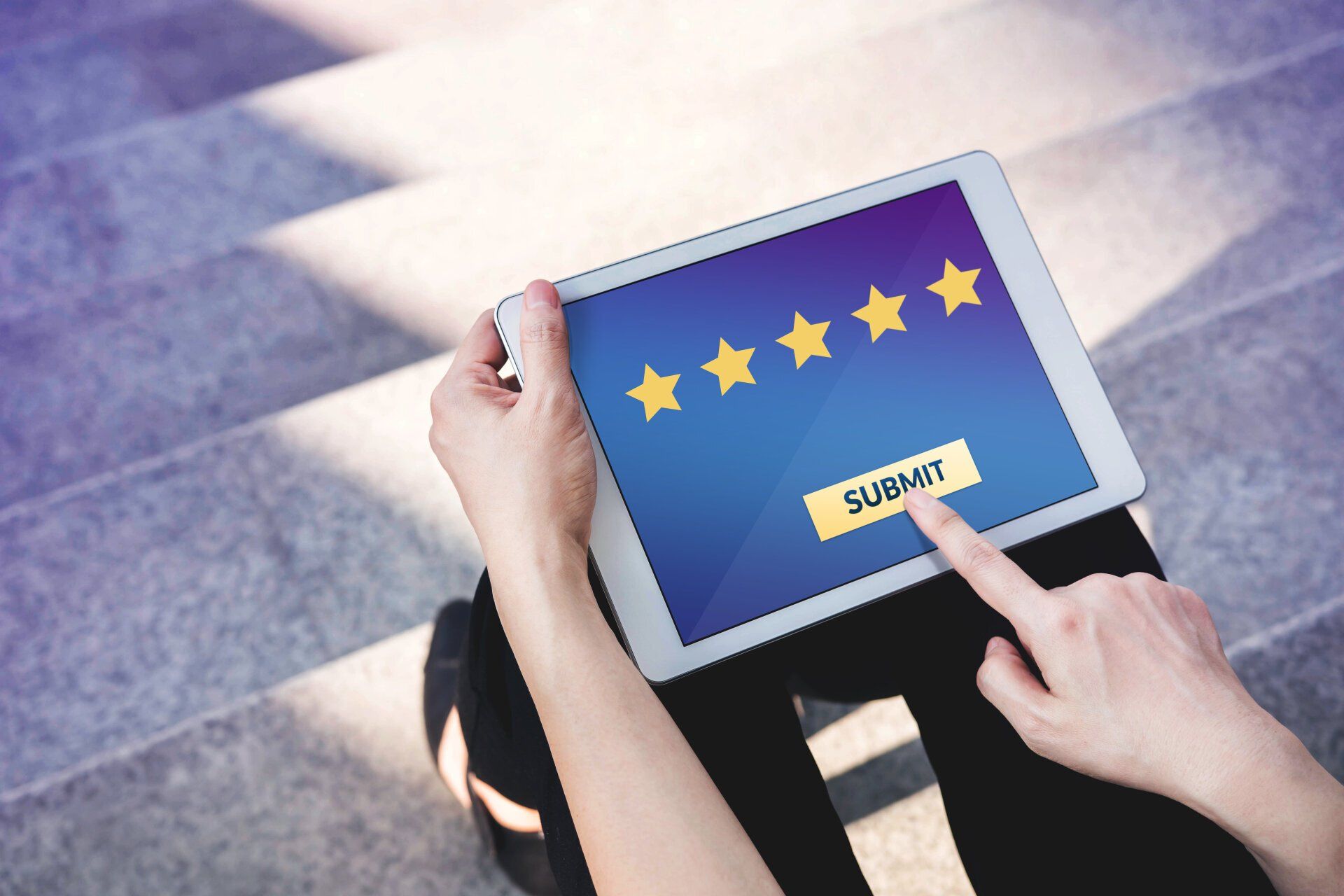 A person holding a tablet shows a five-star rating and a