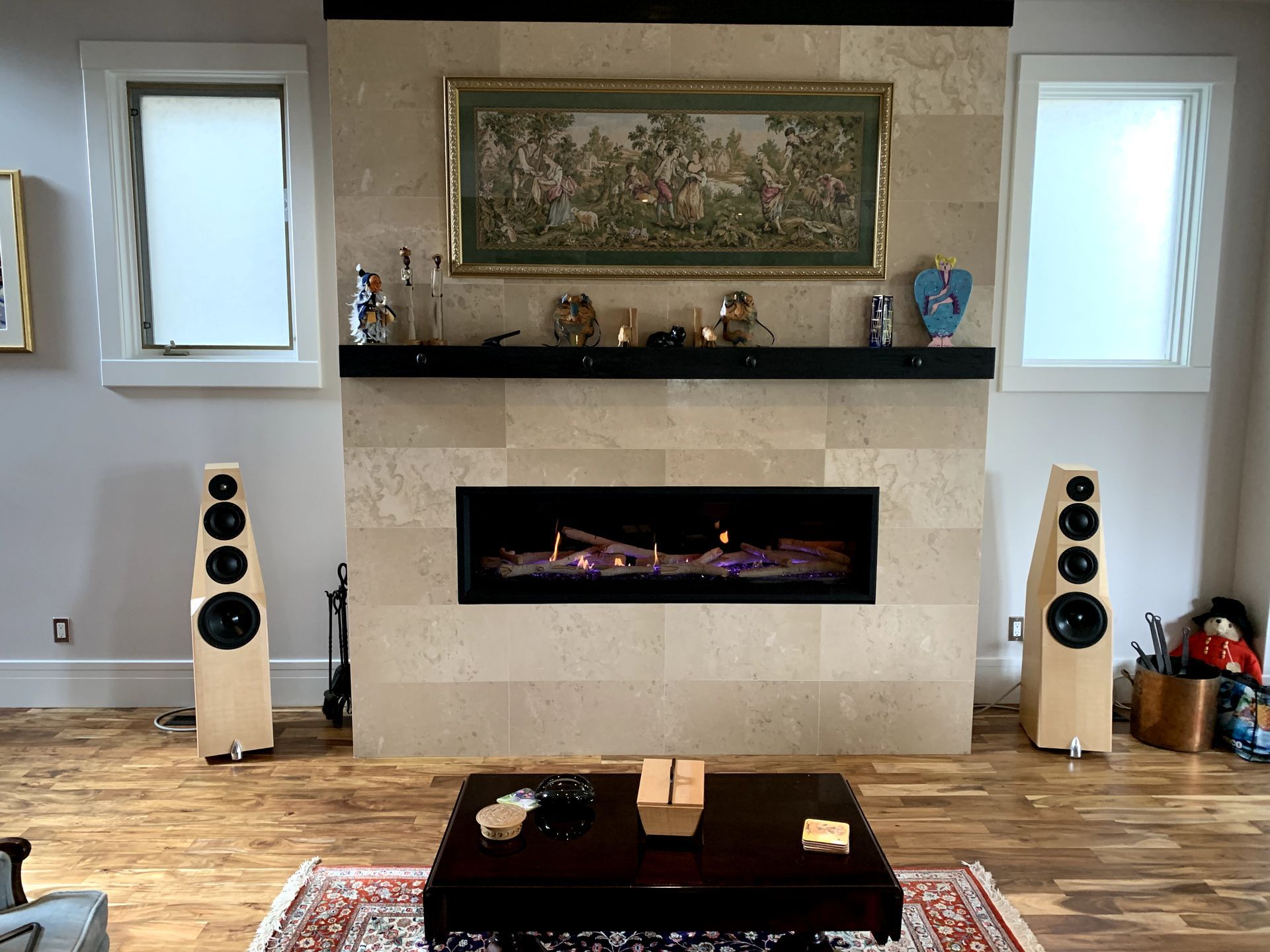 A living room with a fireplace and speakers