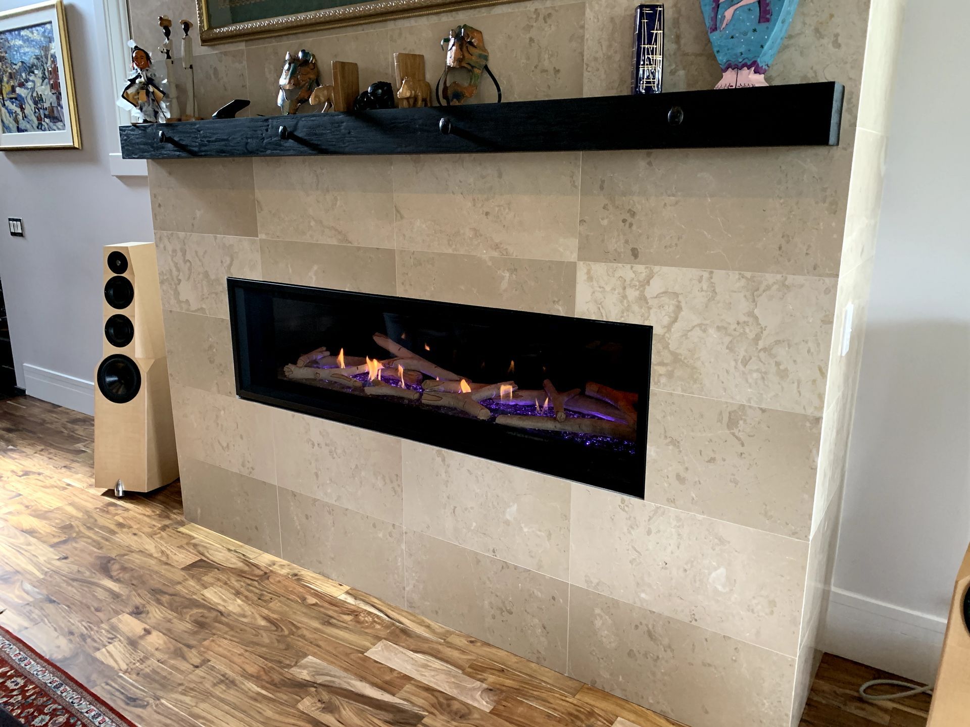 A living room with a fireplace and a mantle.