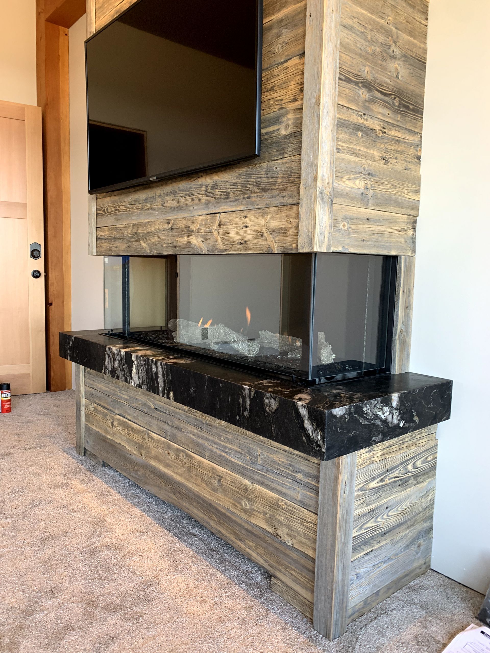 A living room with a fireplace and a flat screen tv.