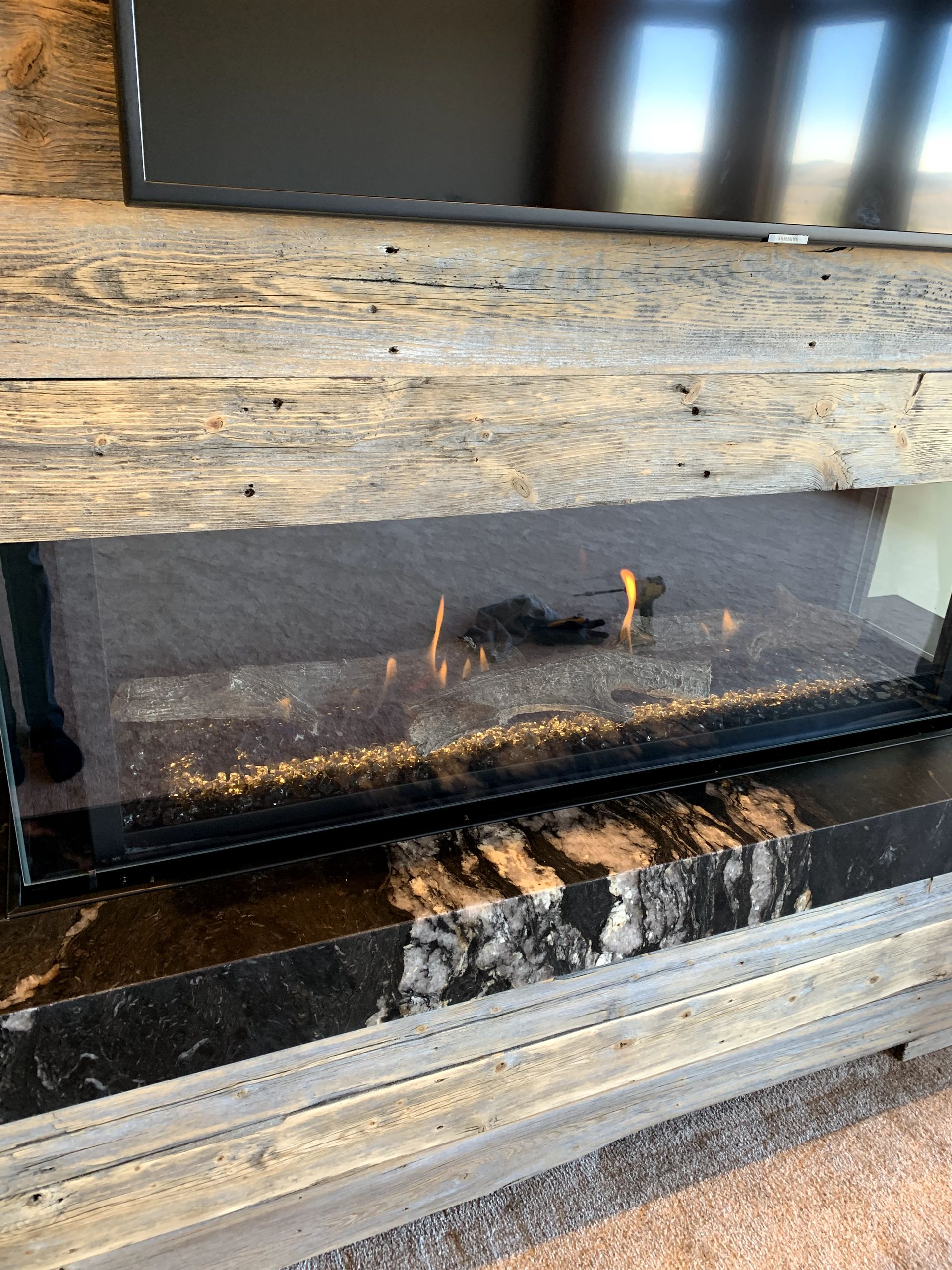 A fireplace with a television above it in a living room.