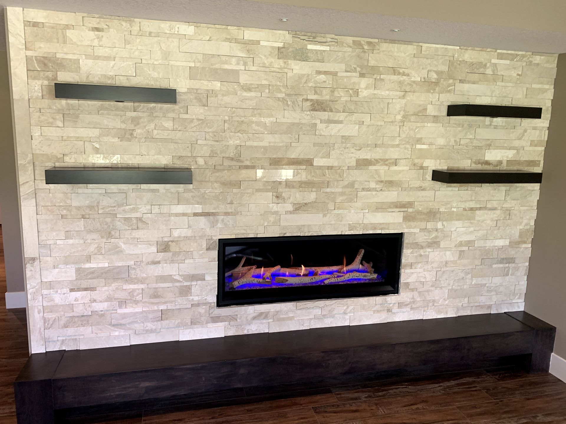 There is a fireplace in the middle of the wall.