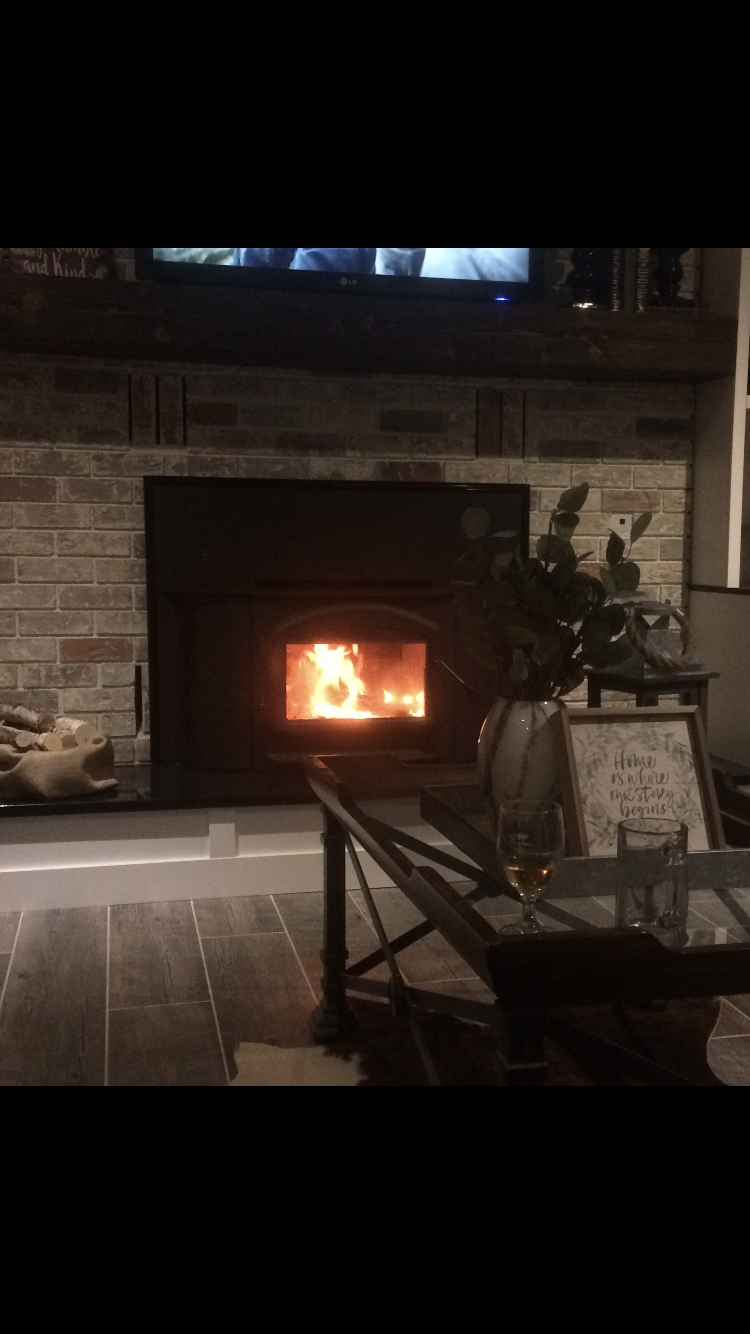 A living room with a fireplace and a coffee table.