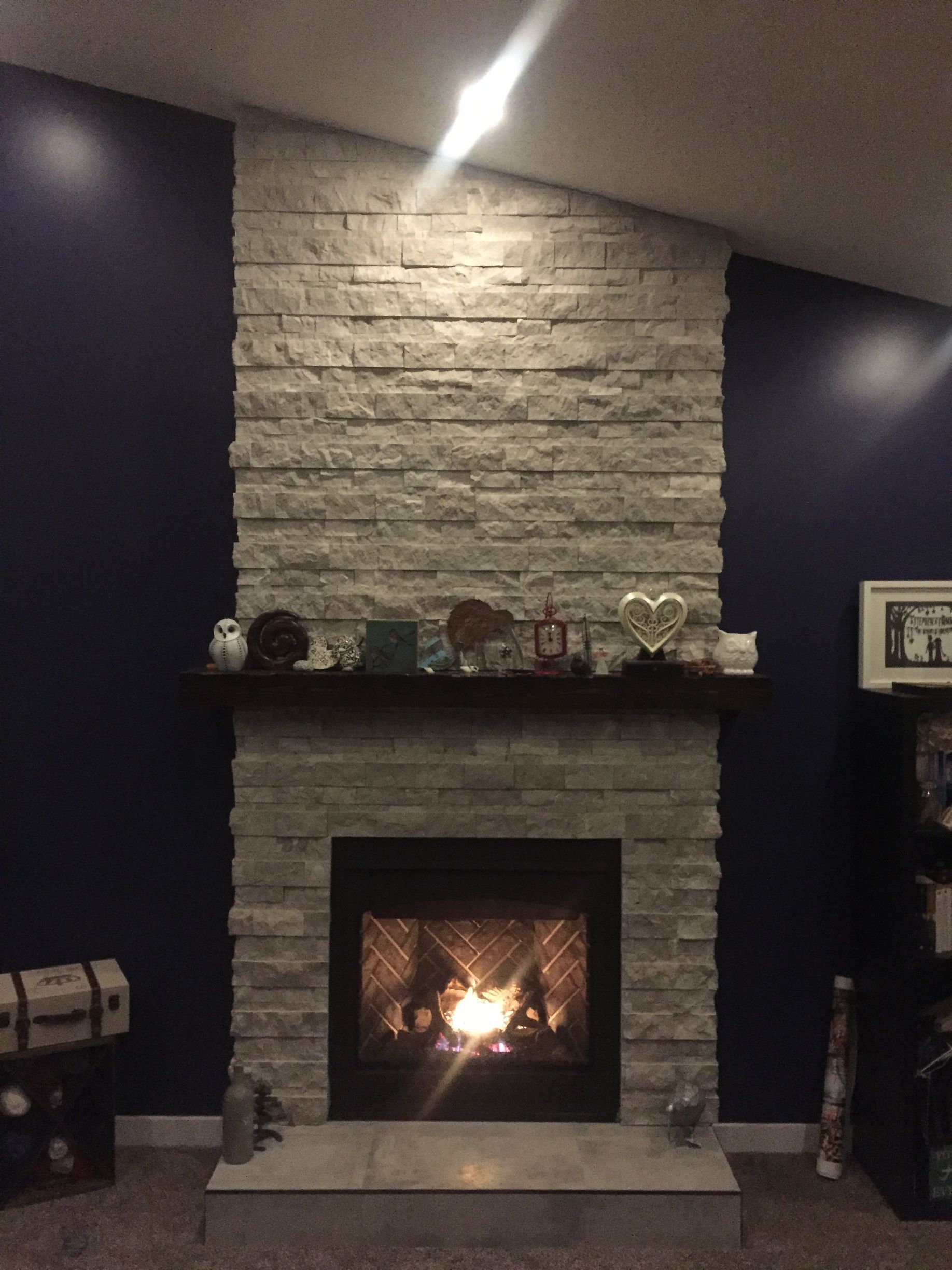 A fireplace in a living room with blue walls