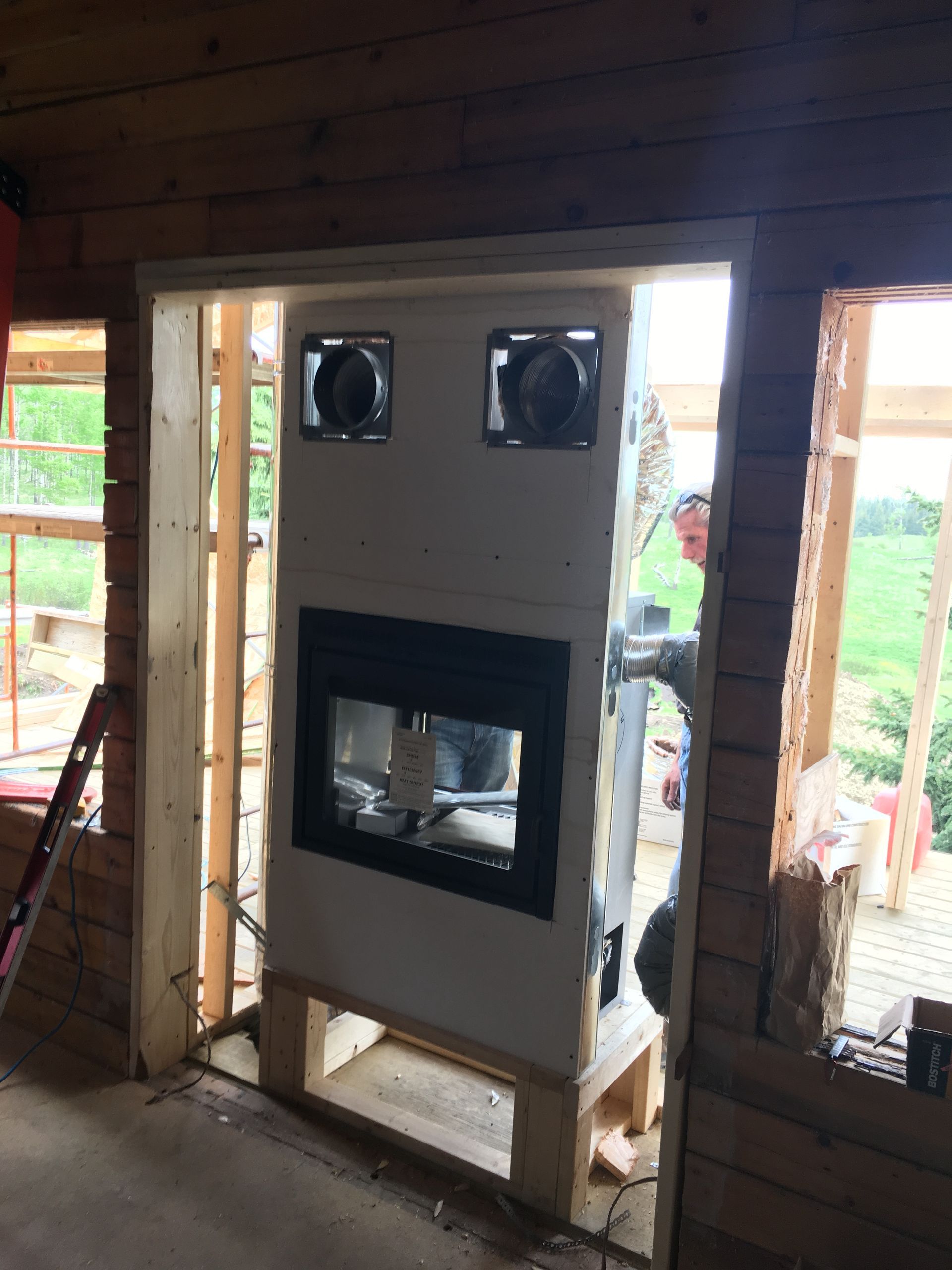 A fireplace is being built in a wooden house