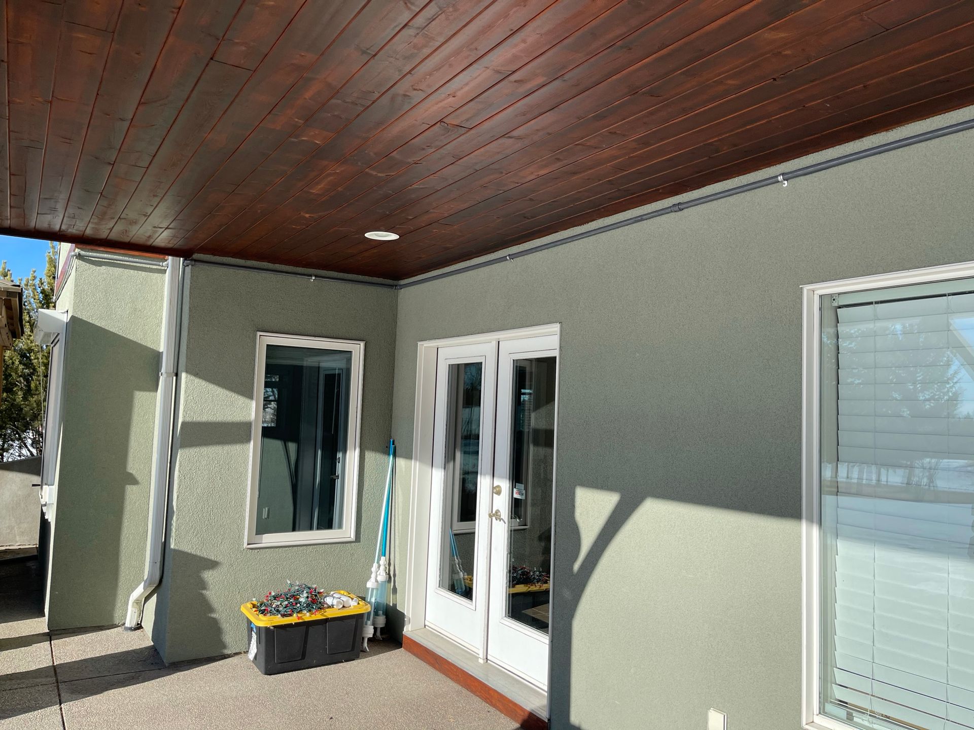 A house with a wooden ceiling and sliding glass doors