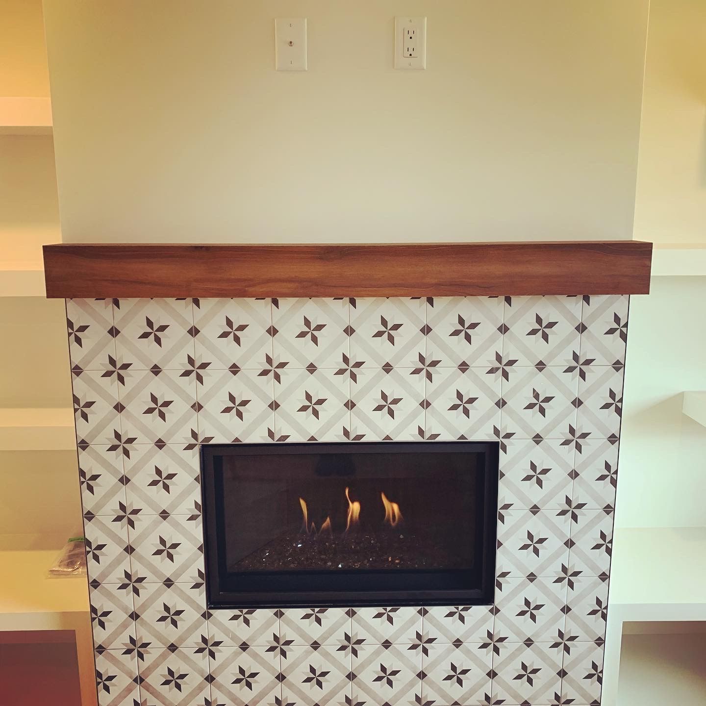 A fireplace with a pattern of flowers on it