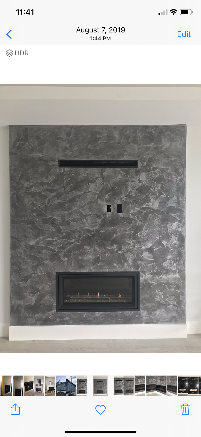 A picture of a fireplace on a wall on a phone.