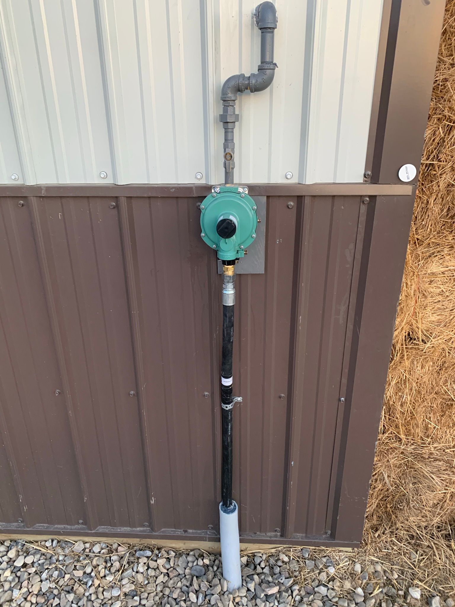 A gas meter is attached to the side of a building.