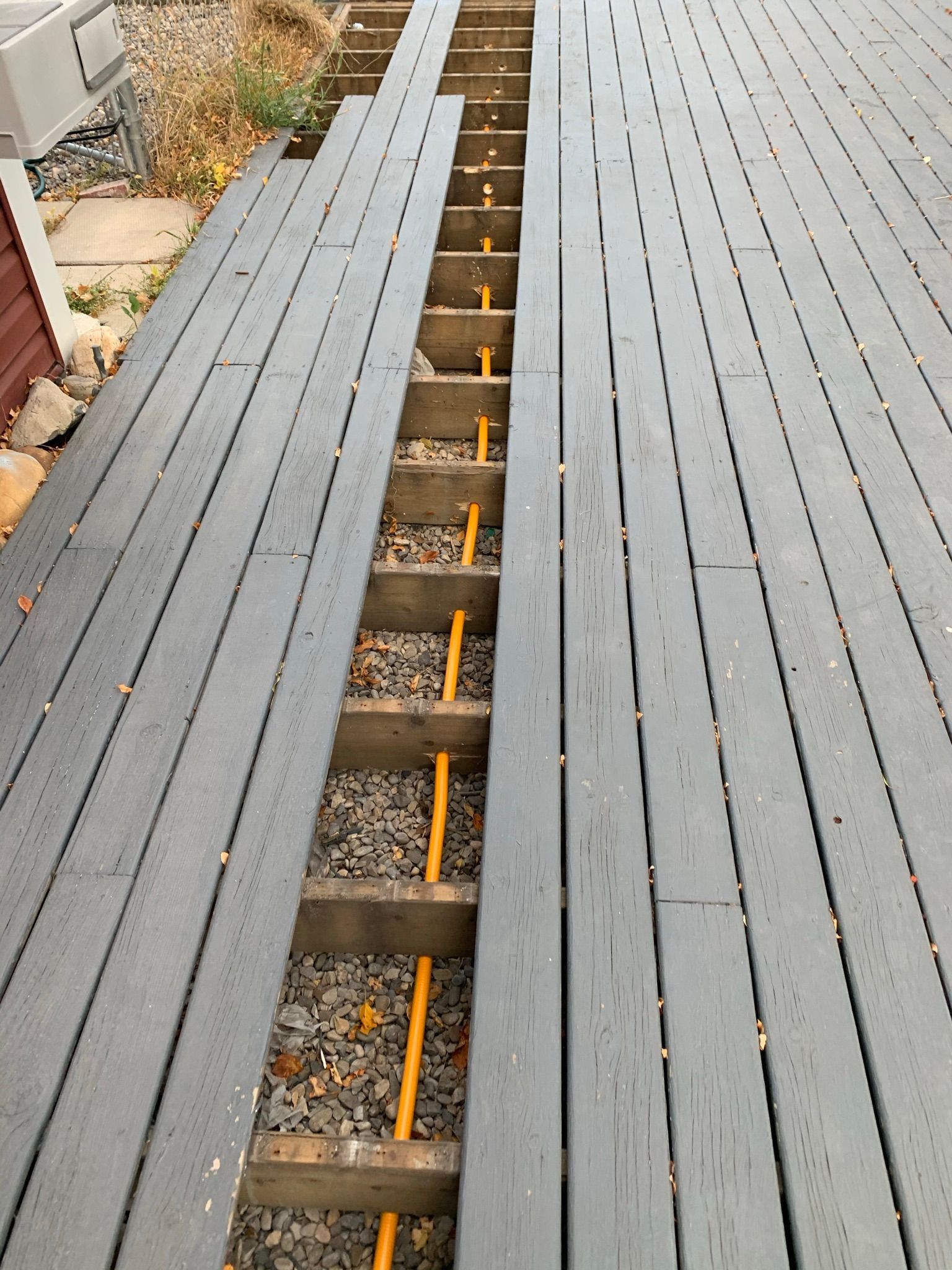 A wooden deck with a hole in the middle of it