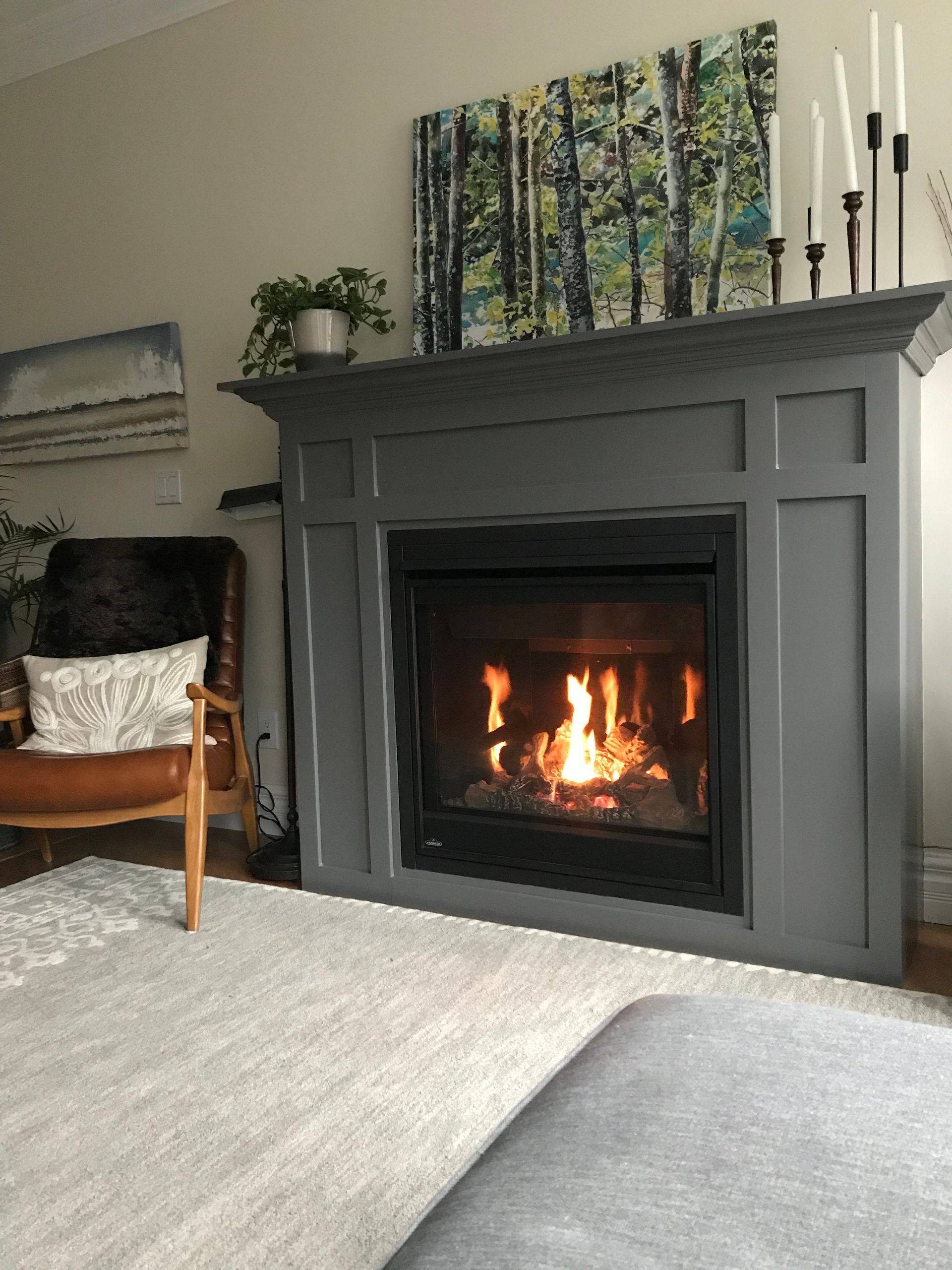 A living room with a fireplace and a chair